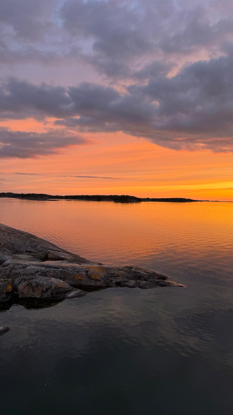 Orange sunset over open water in the archipelago